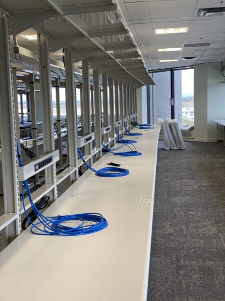 Structured cabling run to workstations in an office setting.