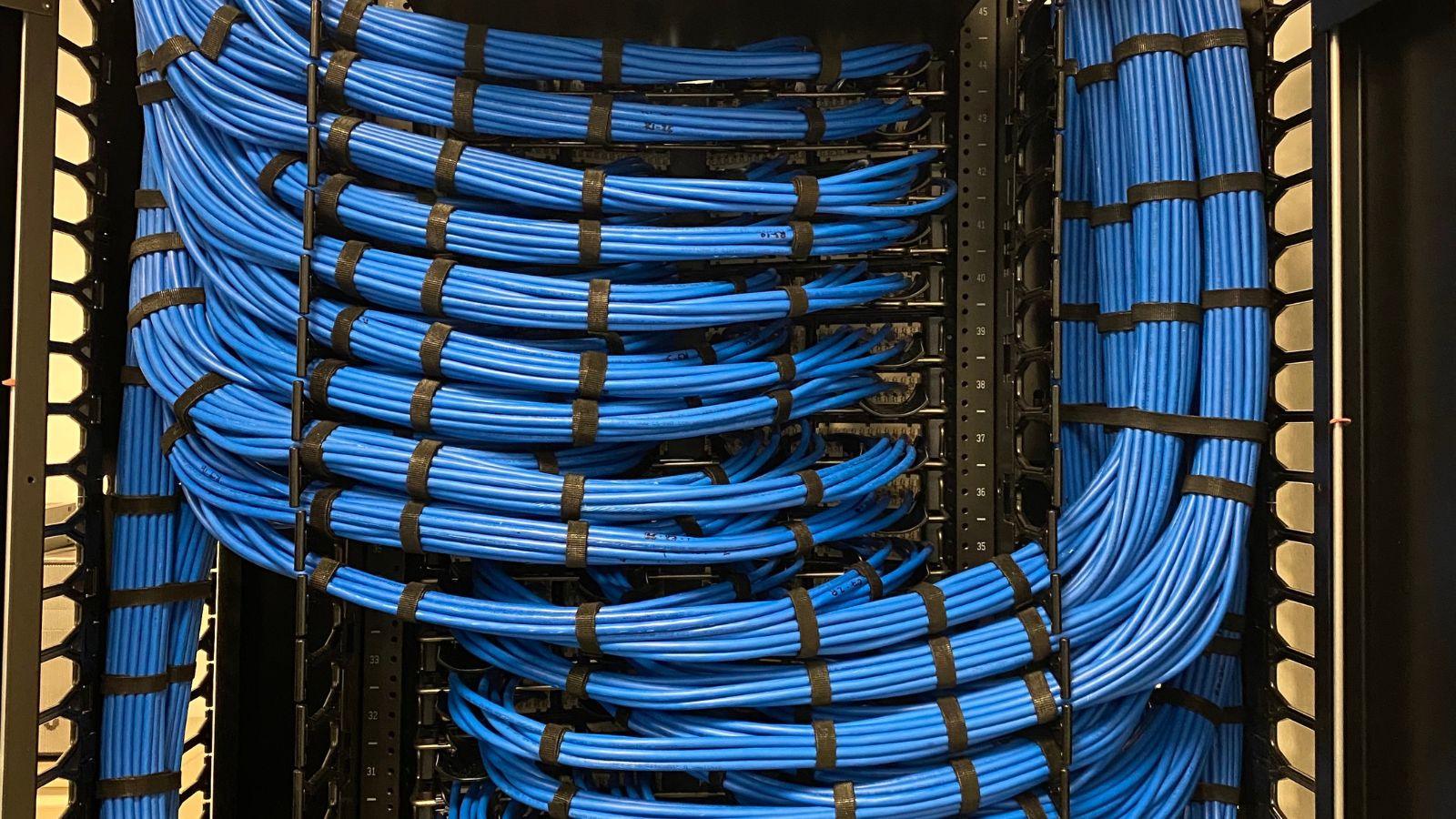 Organized structured cabling installation in a commercial telecom room, installed by CORE Cabling