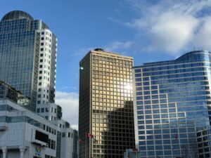 A vibrant view of downtown Vancouver office buildings featuring modern architecture under a clear blue sky.