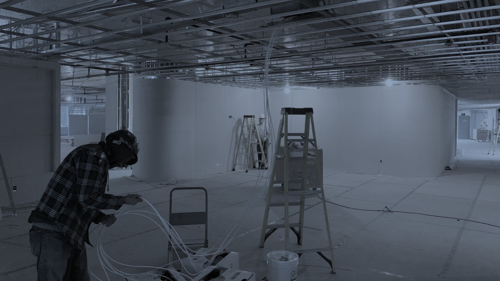 CORE Cabling technicians pulling structured cable in a vacant office settling